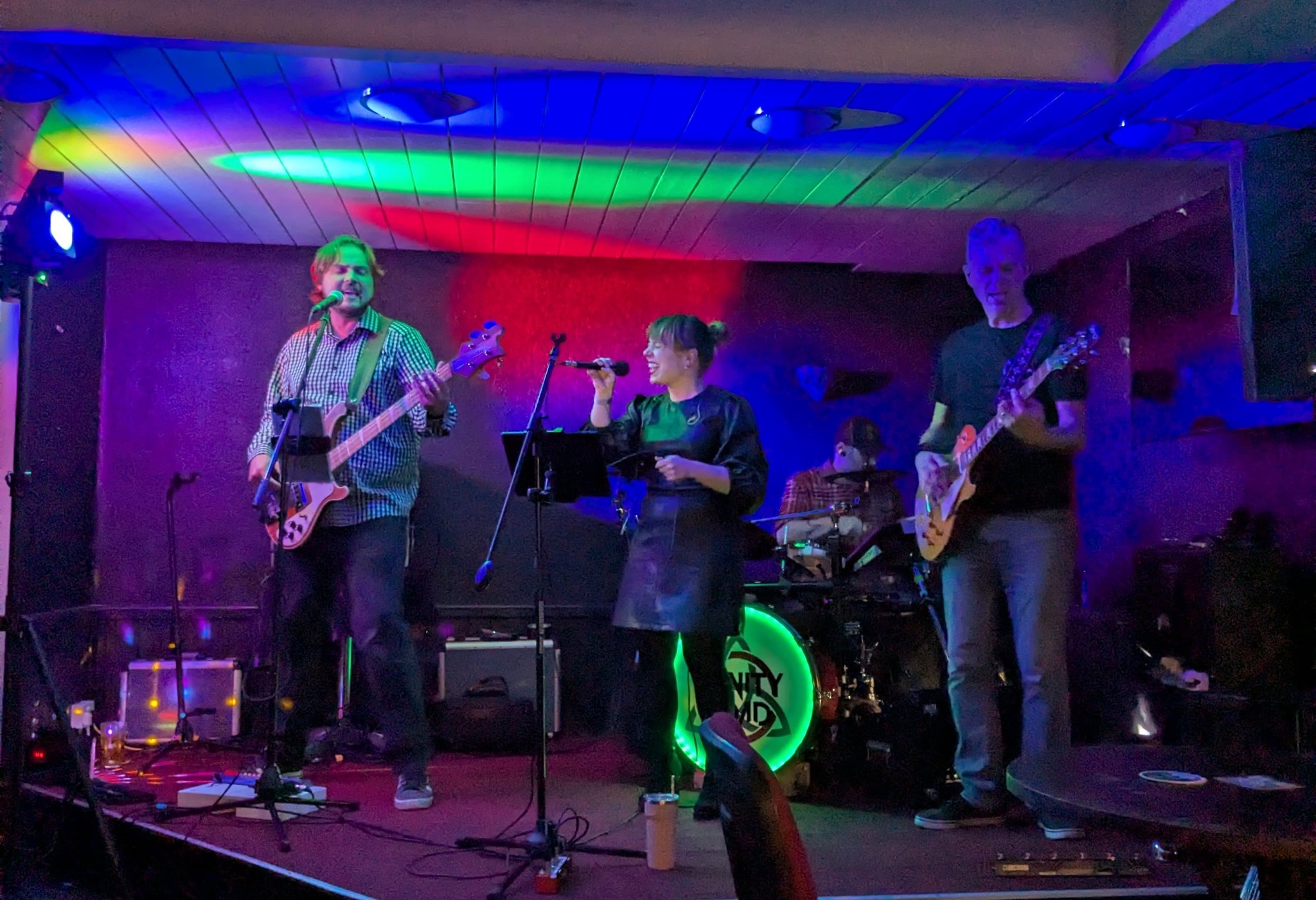 Trinity Road performing live with colourful rainbow stage lighting